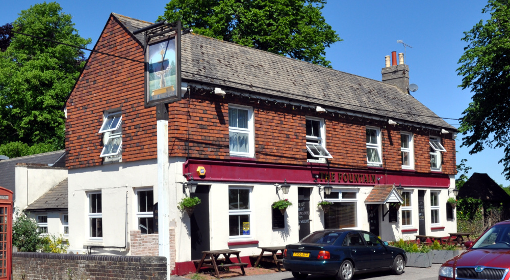 Two-storey brick building with pantiles and a pub sign reading: The Fountain